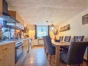 a kitchen with a wooden table and chairs and a dining room at Neef in Neef