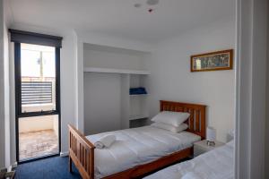 a bedroom with two beds and a window at 1 Duke street in Albany