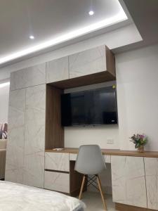 a bedroom with a tv and a desk with a chair at Magica Cartagena Suite in Cartagena de Indias