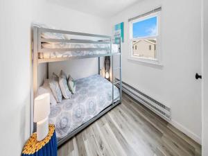 a bedroom with bunk beds with a window at Lbi - Ship Bottom, Duplex Available For Summer 2026 in Ship Bottom