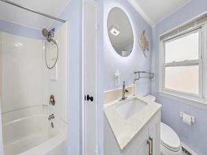 a white bathroom with a sink and a shower at Lbi - Ship Bottom, Duplex Available For Summer 2026 in Ship Bottom