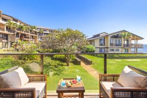 a balcony with two couches and a table at MA-1205 - Ocean Views AC in Koloa