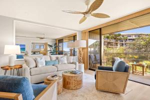 a living room with a couch and a ceiling fan at MA-1205 - Ocean Views AC in Koloa +40 photos