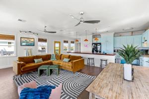 a living room with a couch and a table at Once Upon A Tide in Bolivar Peninsula