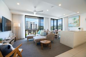 a living room with a couch and a table at X Kirra Apartments in Gold Coast