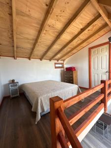 a bedroom with a bed and a wooden ceiling at CIRyT La Montaña - Eco Cabañas y Turismo Rural in Tomé