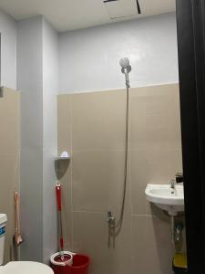 a bathroom with a shower and a toilet and a sink at Maple Leaf Residences - Unit 2 in Southern Davao