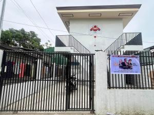 a building with a gate with a sign on it at Maple Leaf Residences - Unit 2 in Southern Davao