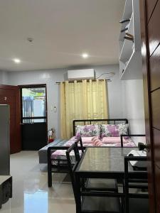 a living room with a table and a couch at Maple Leaf Residences - Unit 2 in Southern Davao