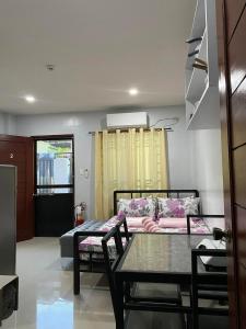 a living room with a table and a couch at Maple Leaf Residences - Unit 2 in Southern Davao +10 photos
