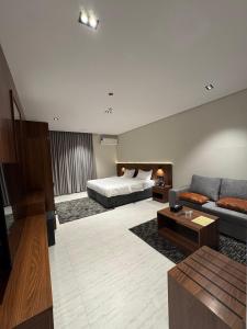 a large living room with a bed and a couch at فندق وفود فرع القريات in Al Qurayyat +68 photos