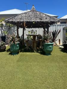 a gazebo with a table and some plants at Whitfords Garden Retreat in Perth
