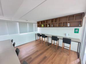 a conference room with a long table and chairs at Flat Premium no Centro de Porto de Galinhas - Próximo as piscinas naturais in Porto De Galinhas +30 photos