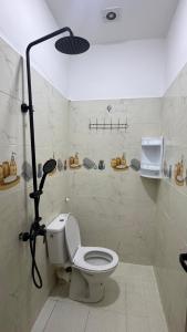 a bathroom with a toilet with a light above it at Riad Mifis in Rissani