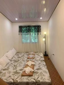 a bedroom with a bed with towels on it at Yaga's Stay INN save in Impasugong