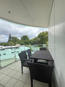 a patio with a table and chairs on a balcony at Apartment 303 Tauranga in Tauranga