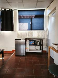 a kitchen with a stainless steel refrigerator in a room at Nirvana 2, Habitación doble con todos sus servicios in Guatemala
