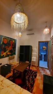 a living room with a table and a chandelier at Hotel & Riad Celia in Marrakesh