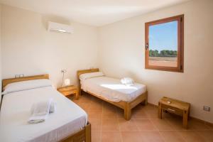 ein Zimmer mit zwei Betten und einem Fenster in der Unterkunft Short De Son Fideu in El Estanyol + 21 Fotos