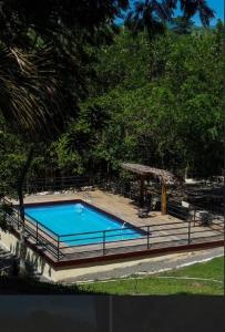 a large blue swimming pool in a park at Villa Gregorio mountain top in Bonao