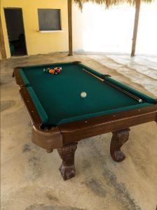 a green pool table with a ball on it at Villa Gregorio mountain top in Bonao +10 photos