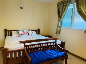 a bedroom with a bed with a blue bench and a window at Happy Mind Resort in Sam Roi Yot +62 photos