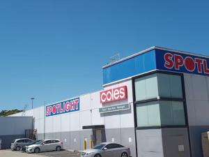 a store with cars parked in a parking lot at Cosy and convenient accommodation in Springvale