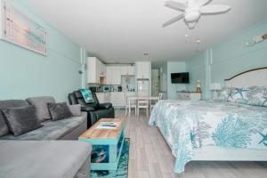 a living room with a bed and a couch at Park Place Unit 130 in Cedar Key