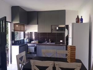 a kitchen with a refrigerator and a table and chairs at Lo de Mili in General Juan Madariaga