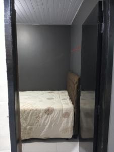 a small bedroom with a bed in a small room at Casa inteira in Ponta Grossa