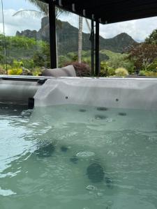 a pool of water in front of a house at Taratara retreat in Kaeo