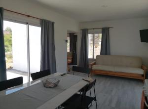 a living room with a table and a couch at Mountain View & Comfort in Villa Santa Cruz del Lago