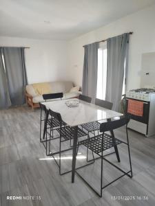 a dining table and chairs in a living room at Mountain View & Comfort in Villa Santa Cruz del Lago +7 photos