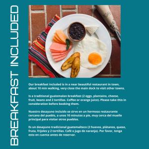 a plate of food with a fried egg and fruit at Hotel Makani in Panajachel +14 photos