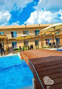 a resort with a swimming pool and a building at JK Beach Club Bar e Pousada in Ibiúna