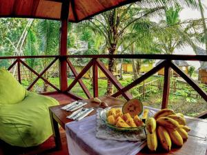 a plate of fruit on a table on a porch at Simeulue Surflodges in Lasikin