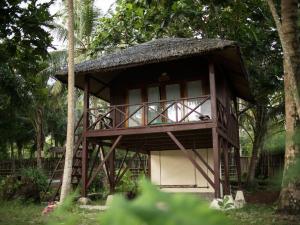 a small building with a grass roof at Simeulue Surflodges in Lasikin