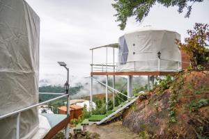 a building with a dome on top of a hill at MonLanna Homesty in Ban Thung Pa Haeo