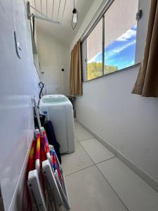 a small bathroom with a toilet and a window at Studio 12 in Santa Cruz Cabrália