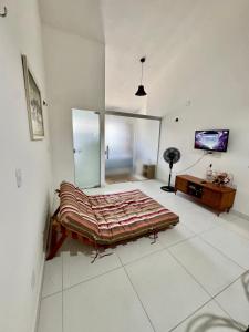 a bedroom with a large bed and a desk at Studio 12 in Santa Cruz Cabrália