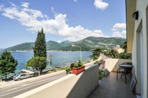 a balcony of a building with a view of the water at Apartmani P&M in Tivat