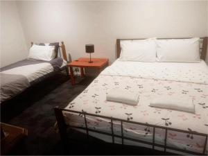 a bedroom with a bed and a small table at Easy Self Check-in accomodation in Springvale