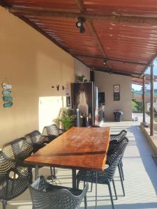a wooden table and chairs on a patio at JK Beach Club Bar e Pousada in Ibiúna