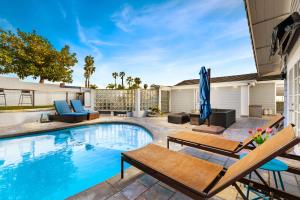 a swimming pool with two chairs and a table at Stunning View Estate with Pool & Game Room in La Mesa
