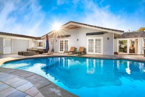 a swimming pool in front of a house at Stunning View Estate with Pool & Game Room in La Mesa +42 photos