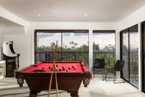 a red pool table in a room with windows at Stunning View Estate with Pool & Game Room in La Mesa