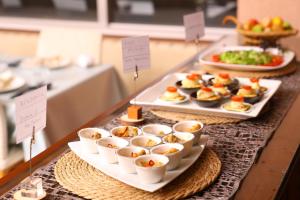 a buffet with plates of food on a table at Hotel Takimoto in Yamanouchi