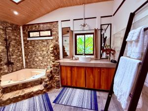 a bathroom with a tub and a sink at Casa Del Bambu in Puerto Jiménez +44 photos