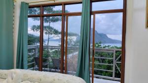 a room with a window with a view of the ocean at Forest Camp El Nido Extension in El Nido