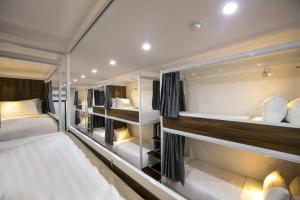 a large room with two beds and several shelves at Hanoi Train Street Hostel in Hanoi